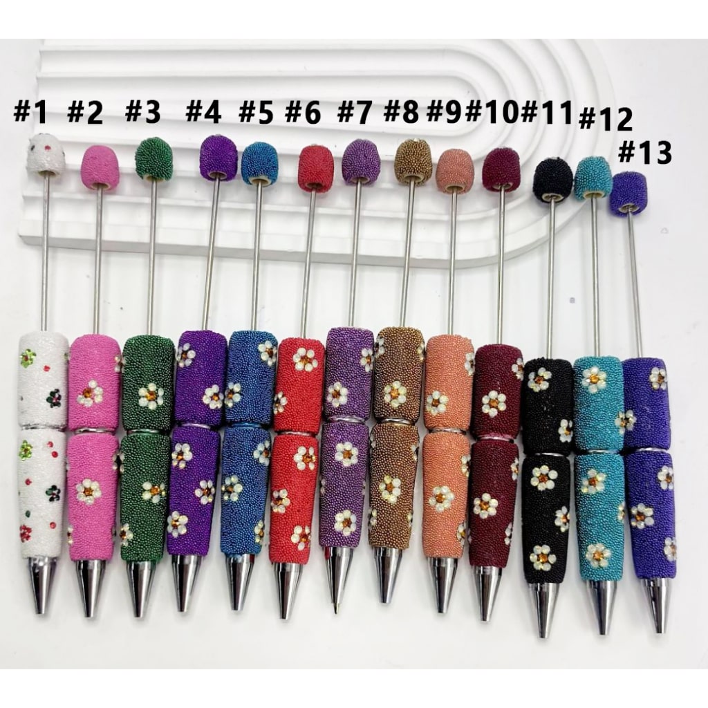 Set of colorful pens with floral designs on white background

