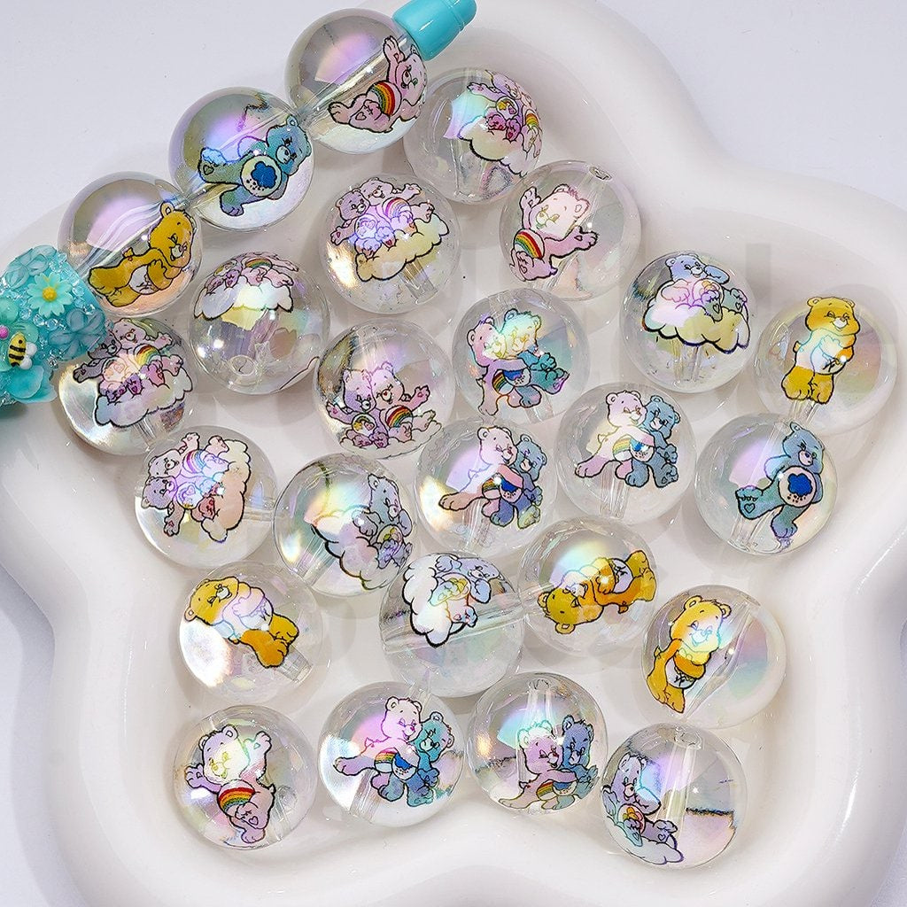 Translucent beads with cartoon bear designs on a white heart-shaped base

