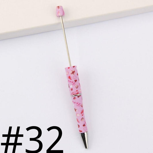 Pink pen with floral design on a white background