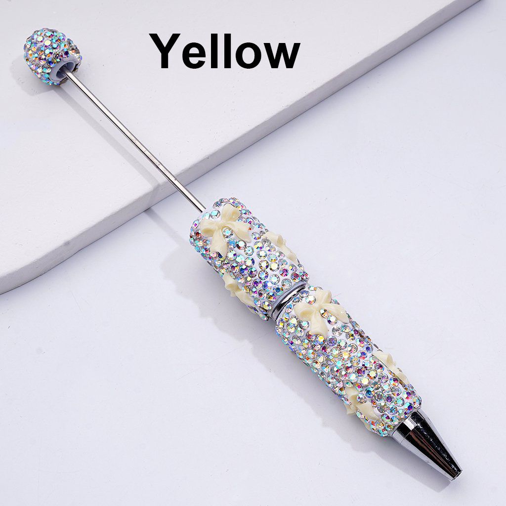 Decorative pen with rhinestone accents on a white background

