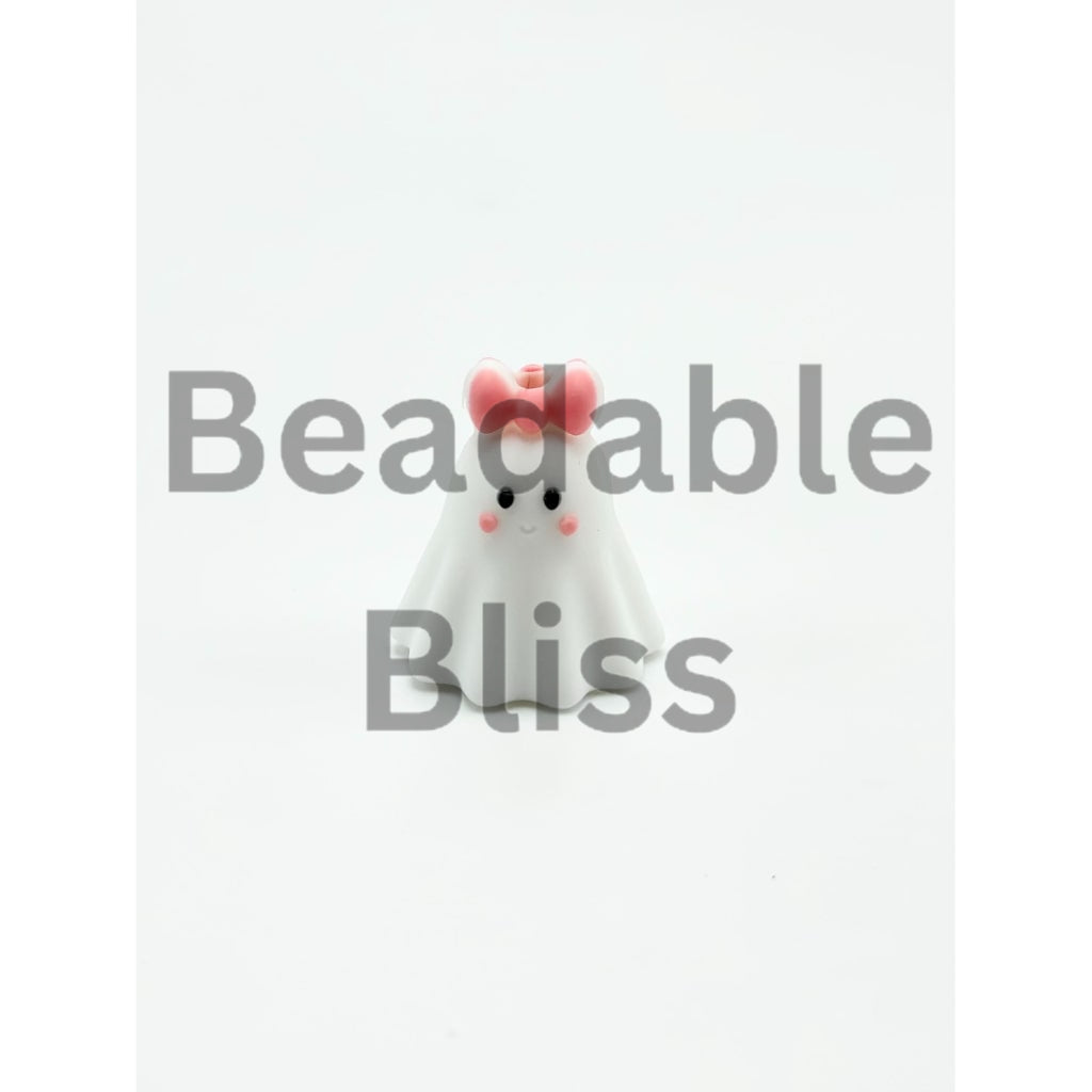 White ghost figurine with a pink bow on a white background

