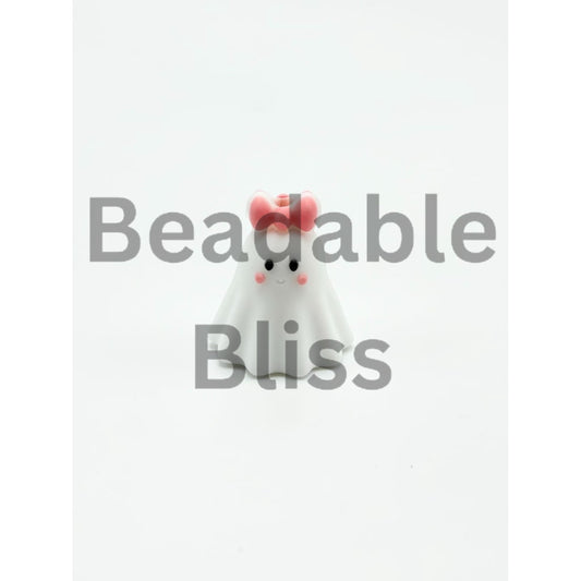 White ghost figurine with a pink bow on a white background

