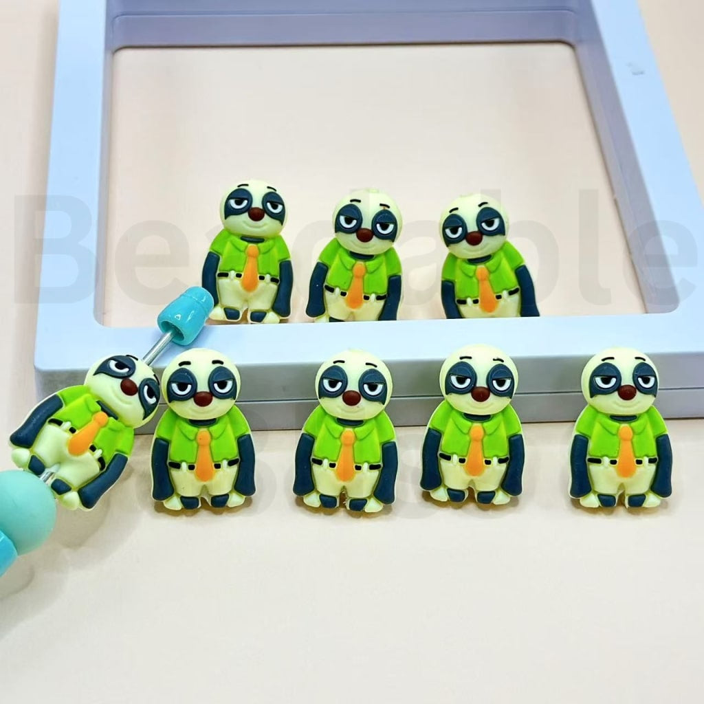 Set of cartoon frog figurines wearing green outfits with orange ties on a white background.

