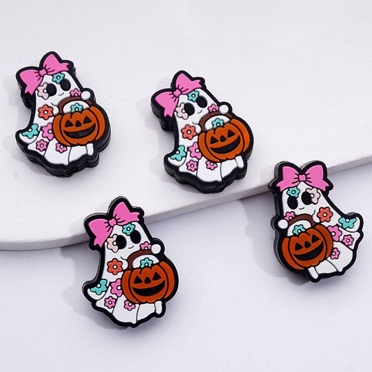 Four Halloween-themed pins featuring ghosts with pink bows and pumpkins on a white background.

