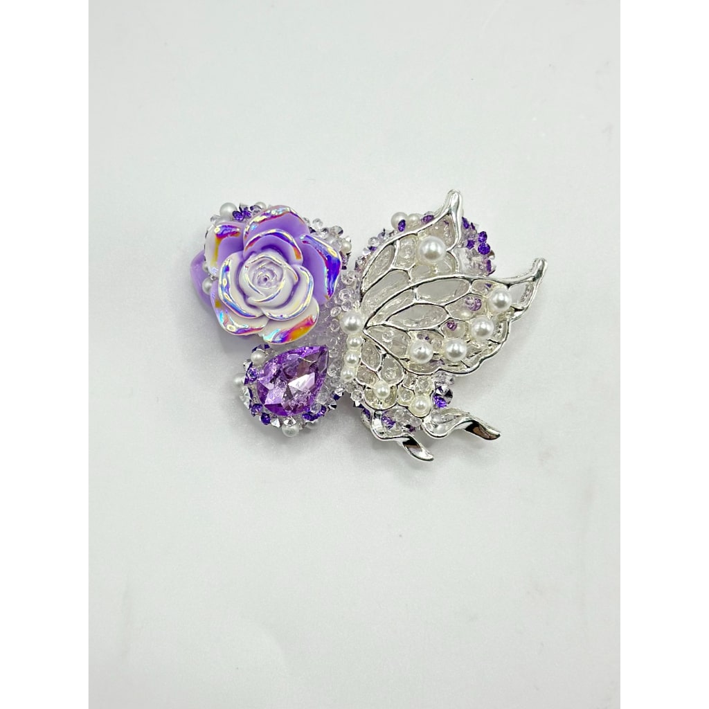 A collection of alloy butterflies with pearls and rhinestones in various colors.

