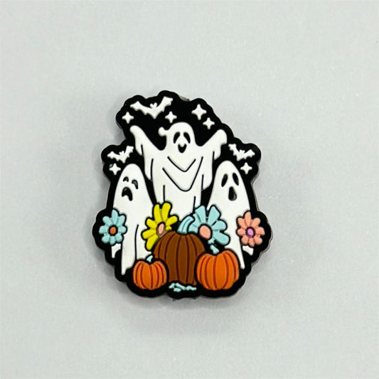 A silicone bead featuring a design with white ghosts, black bats, orange pumpkins, and colorful flowers on a white background.

