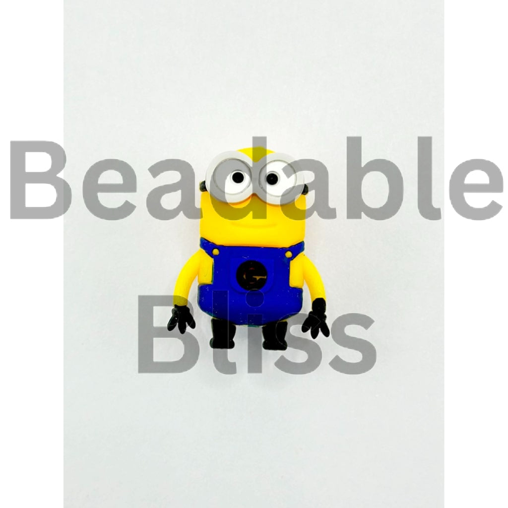 Yellow and blue toy figure on a white background with 'beadablebliss' branding.

